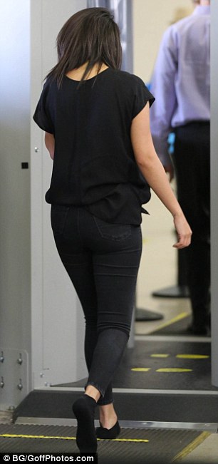 Selena goes through security photo BG Goffphotos com