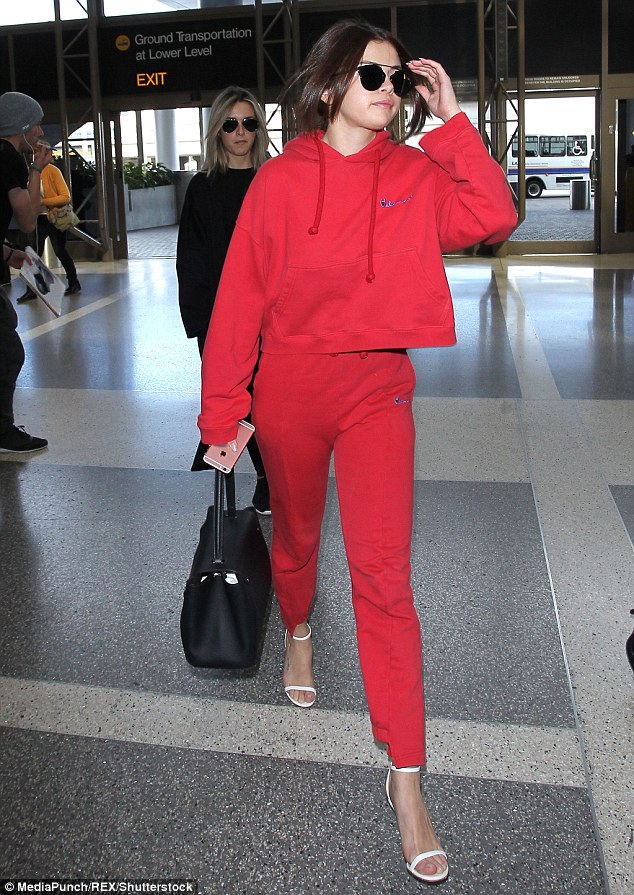 Selena Gomez red tracksuit LAX white sandals black bag photo MediaPunch REX Shutterstock