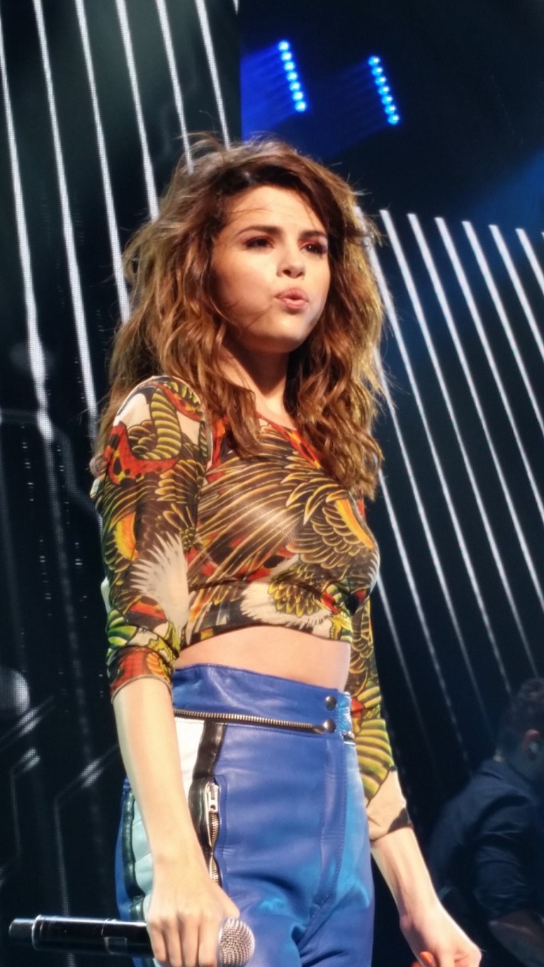 Selena Gomez feather crop top blue trousers Revvial Tour photo hokulele