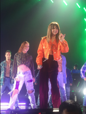 Selena gomez orange jacket and bra maroon trousers Revival tour photo mintzebra