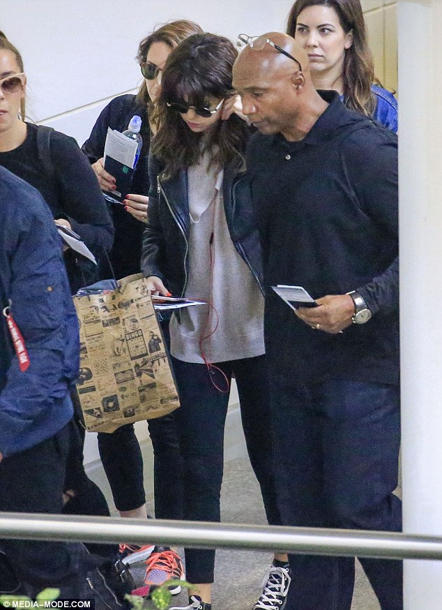 Selena Gomez style grey double layer sweater white bag black leather jacket Brisbane airport revival tour august 2016 photo media-mode com
