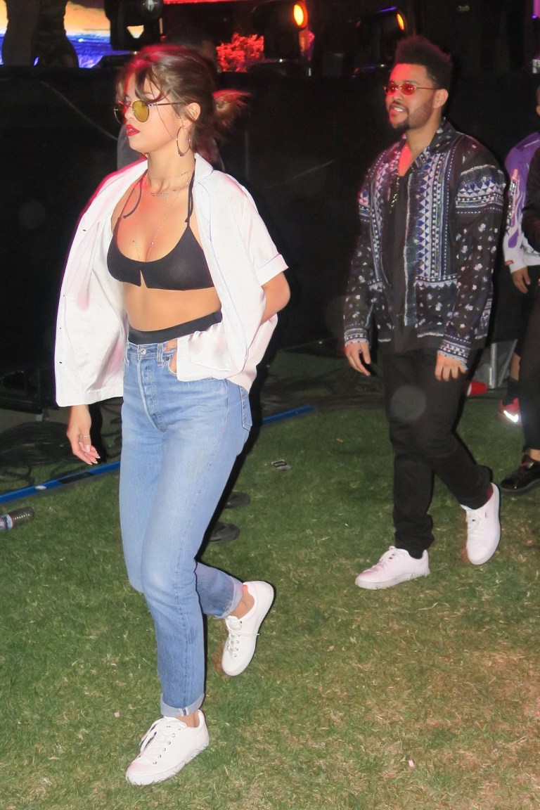 Selena Gomez black bra white shirt jeans white sneakers Coachella April 2017