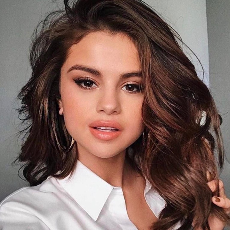 Selena Gomez white shirt gold hoops Pantene