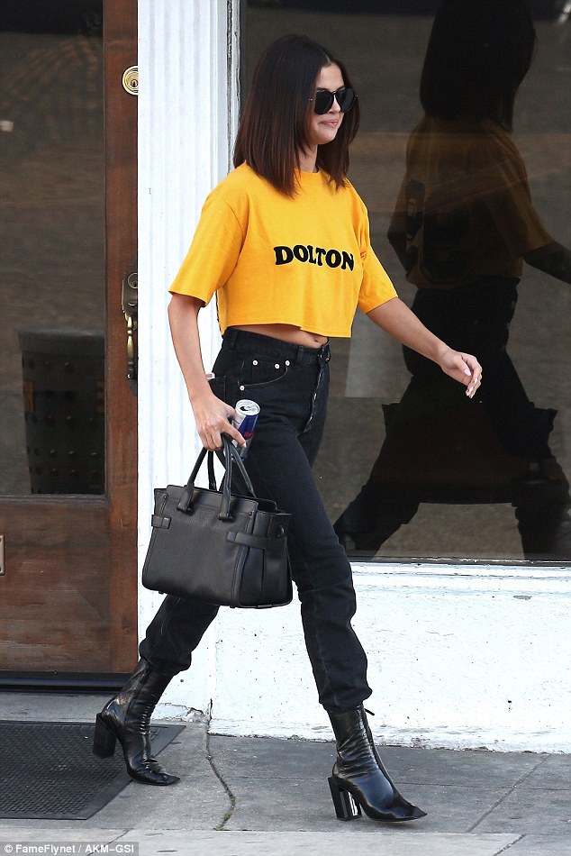 Selena Gomez yellow Dolton cropped top black jeans photo FameflyNet AKM-GSI