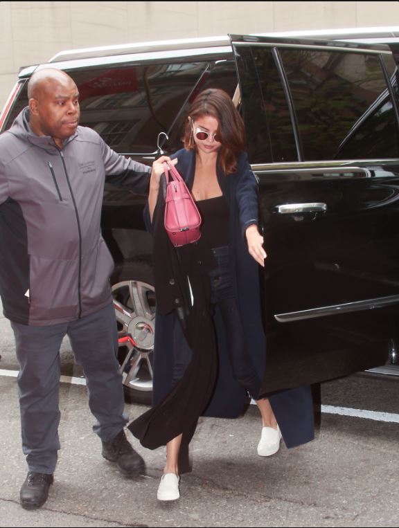 Selena Gomez blue coat black top white sneakers trainers red bag New york May 1 2017