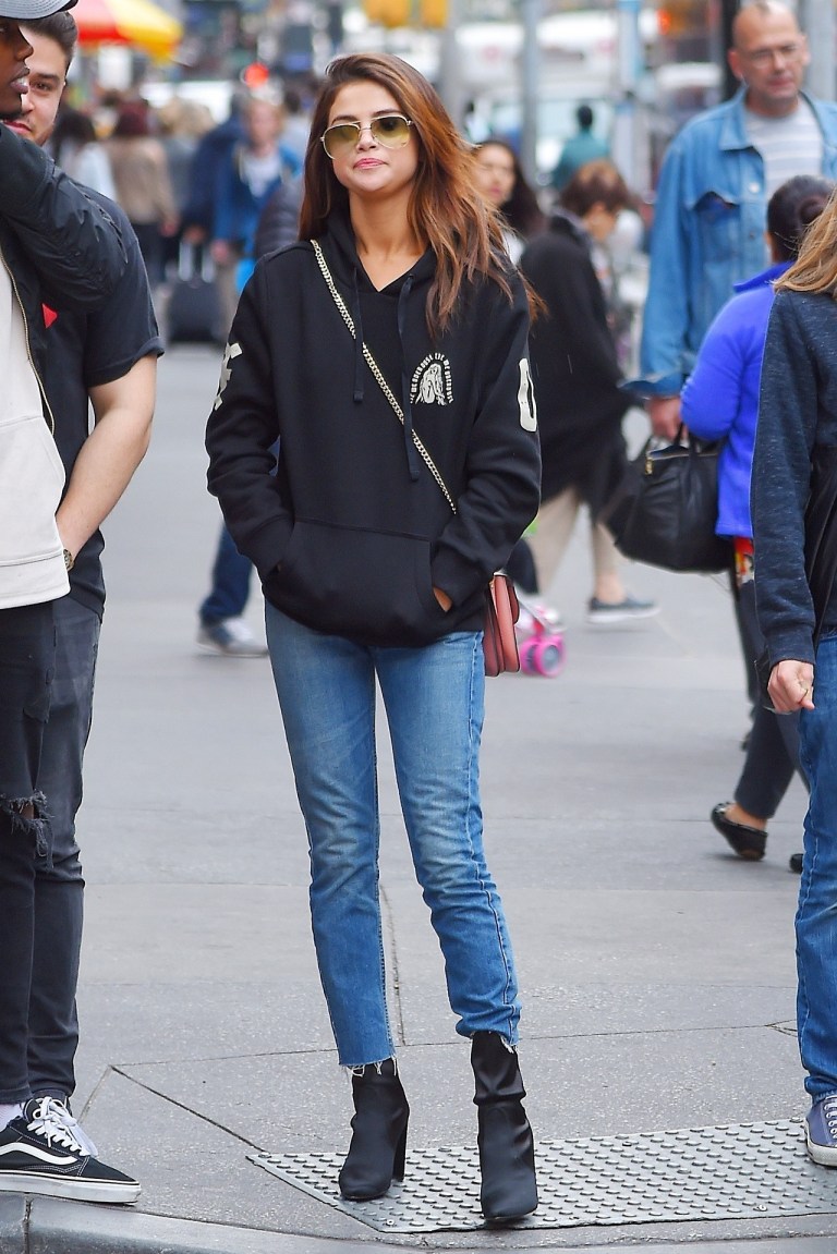 Selena Gomez black hoodie black boots Times Square NY 4 June 2017