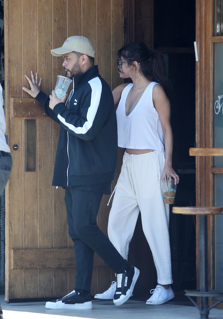 Selena Gomez white v neck tank white sneakers trainers July 2017 photo Clint Brewer Splash News
