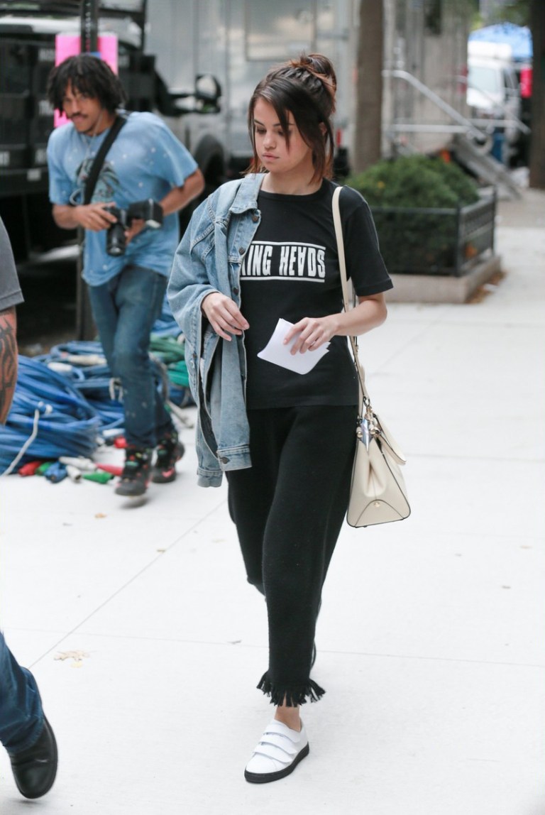 Selena Gomez Talking heads t-shirt fringe trousers white bag September 2017 Selena Gomez street style 2017