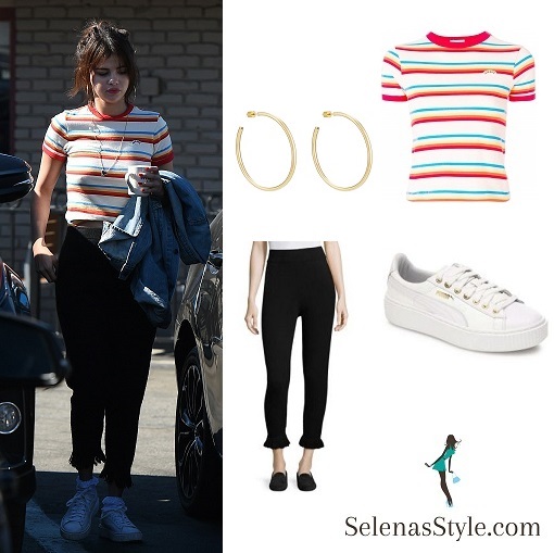Selena Gomez style orange and white striped tee black fringed trousers white trainers hoop earrings February 2018 photo WENN