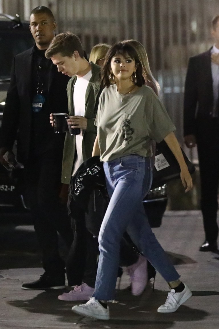 Selena Gomez style green t-shirt blue jeans white sneakers May 19 2018