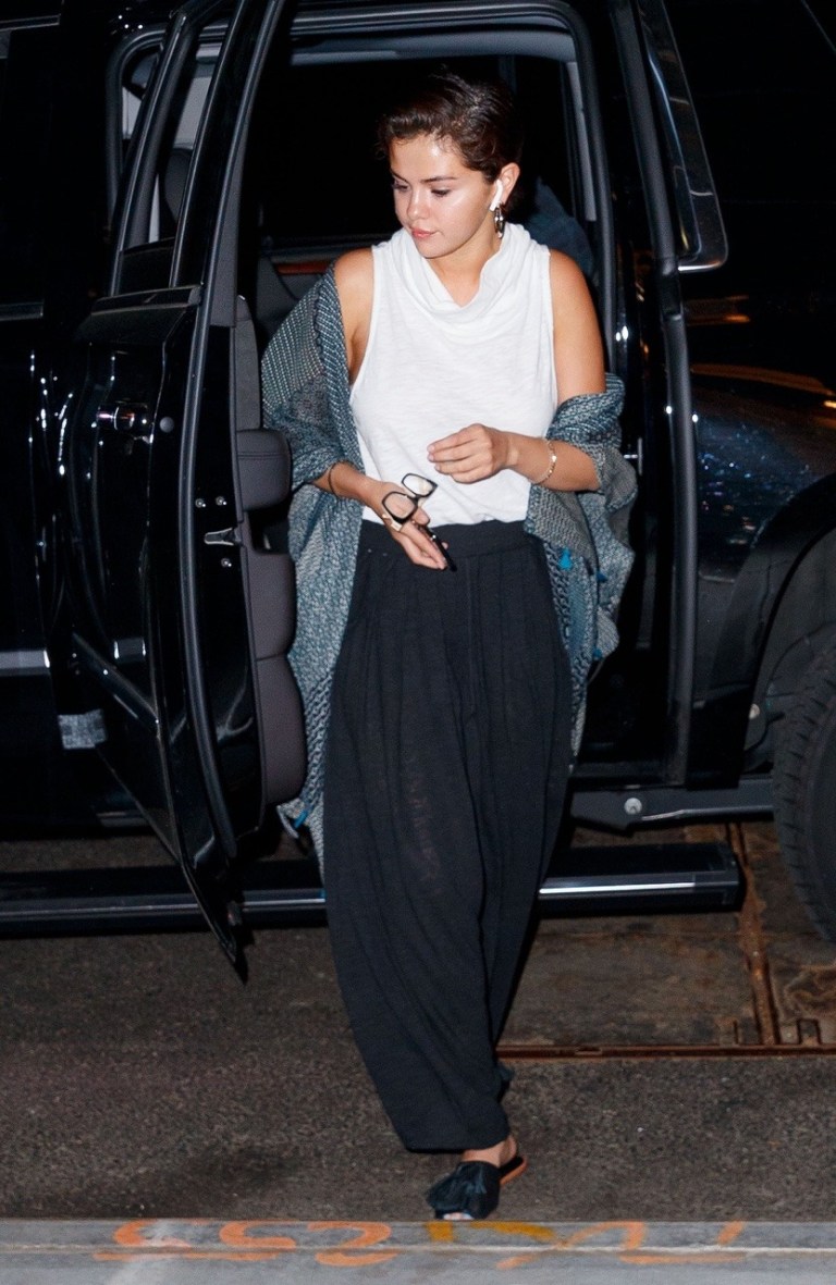Selena Gomez style white cowl top black trousers grey shawl may 6 2018