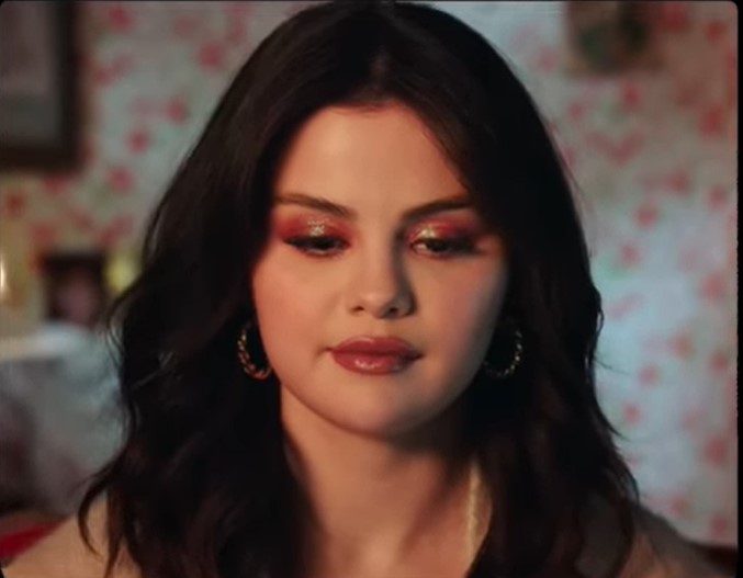 where to get all Selena Gomez outfits ivory lace dress cream short sleeve cardigan twisted gold hoops 15 September 2021 Photo Selena Gomez Artist Spotlight Stories