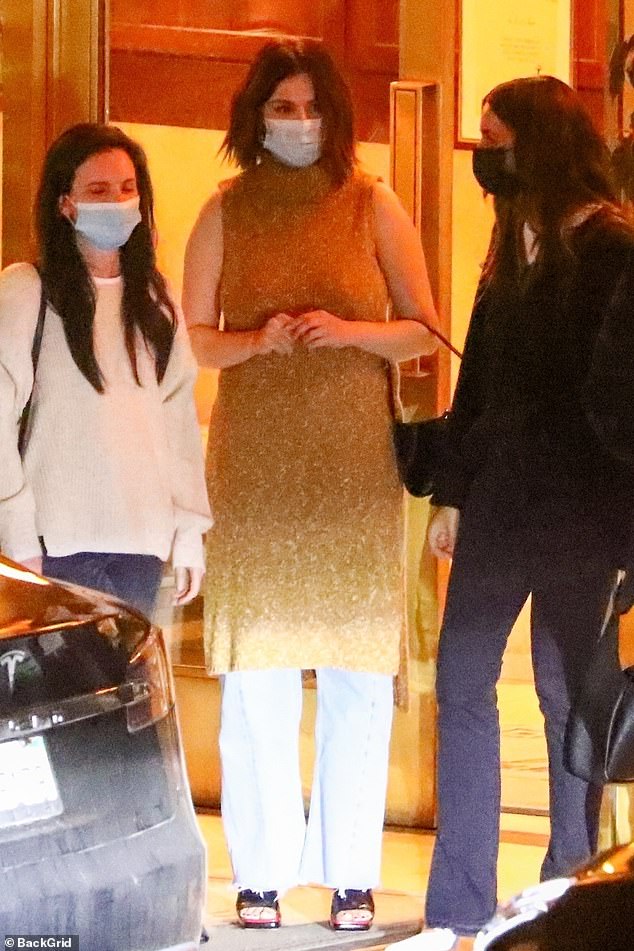 where to get all Selena Gomez outfits camel sleeveless dress jeans black patent mules black patent handbag 1 November 2021 Photo Backgrid