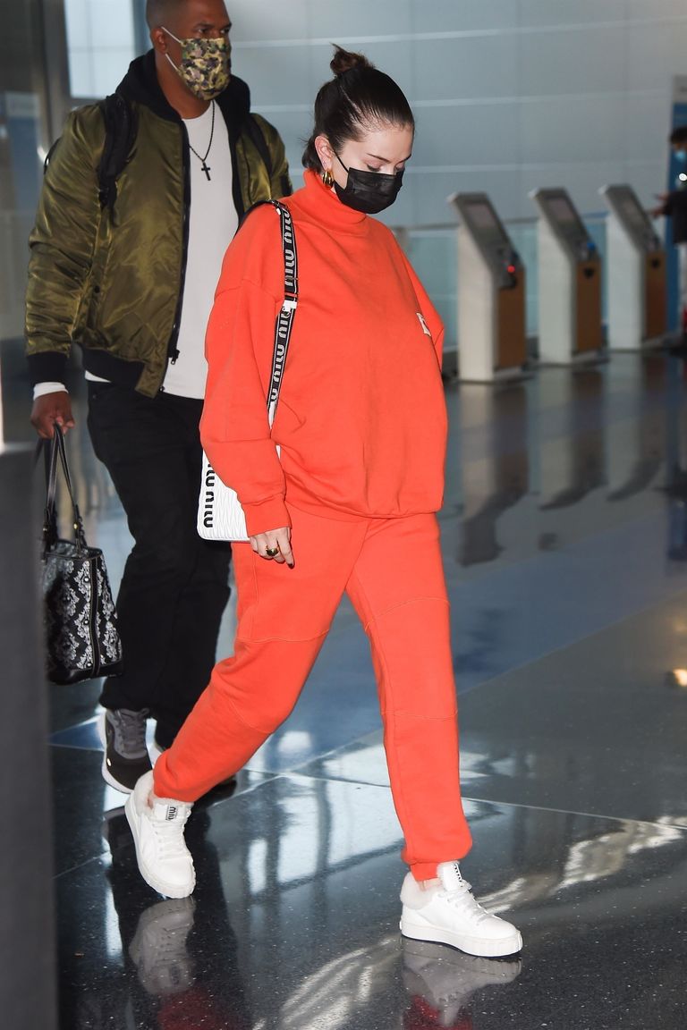 where to get Selena Gomez orange re sweatsuit white trainers Miu Miu bag New york 22 november 2021 Photo Backgrid