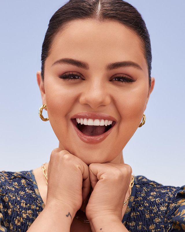 where to get all Selena Gomez outfits navy floral shirred dress gold twist hoops gold chain necklace Rare Beauty 9 December 2021