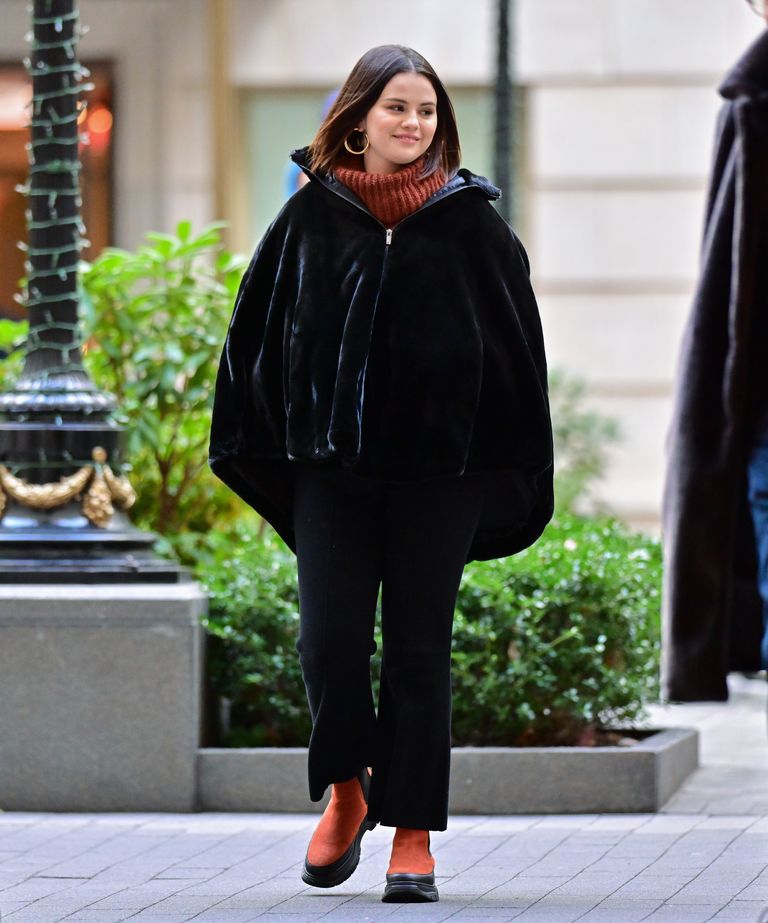 where to get Selena gomez black velvet cape brown cable jumper tan suede chelsea boots Only Murders in The building December 2021 Photo Gotham